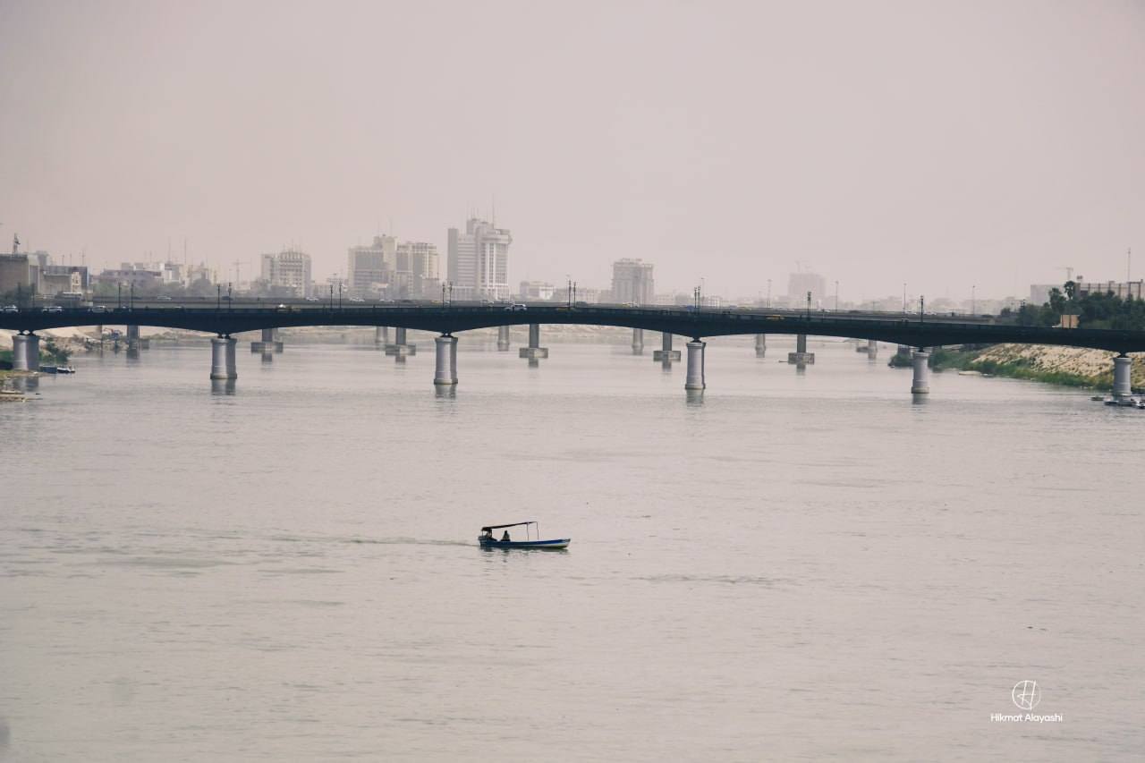 boat on the Tigris River beneath a bridge in Baghdad