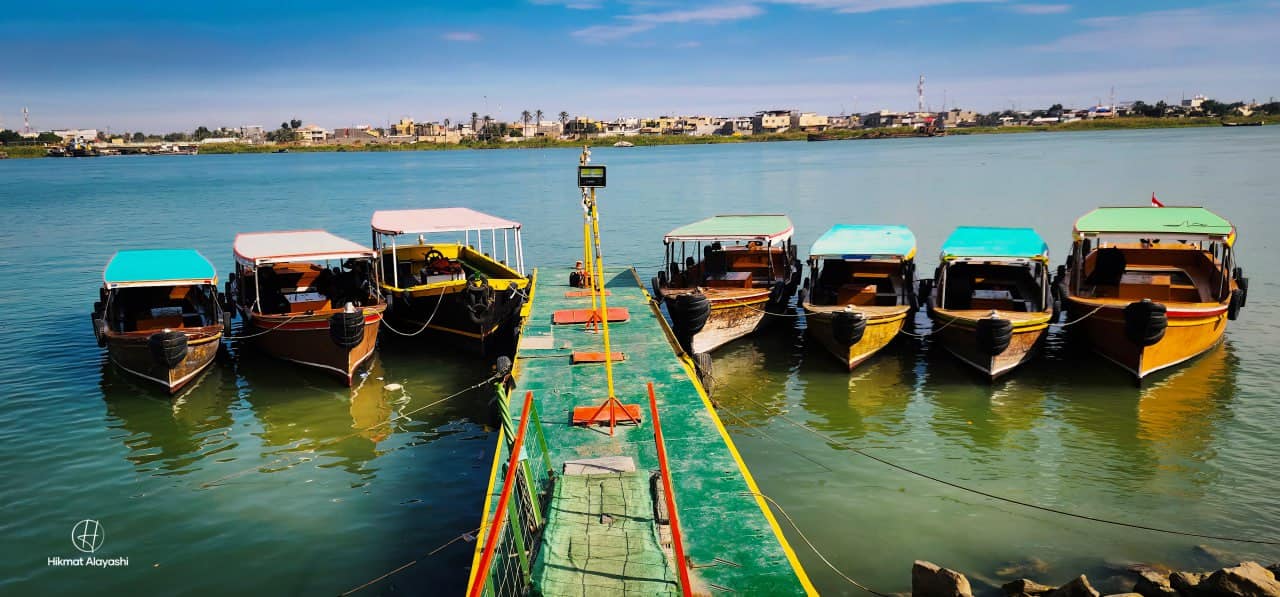 small colorful boats moored on the river in Basra