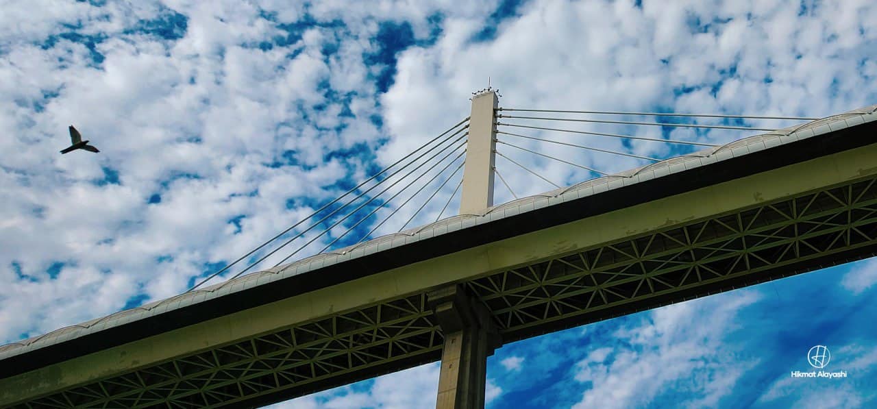 bridge in Basra against a cloud-filled blue sky
