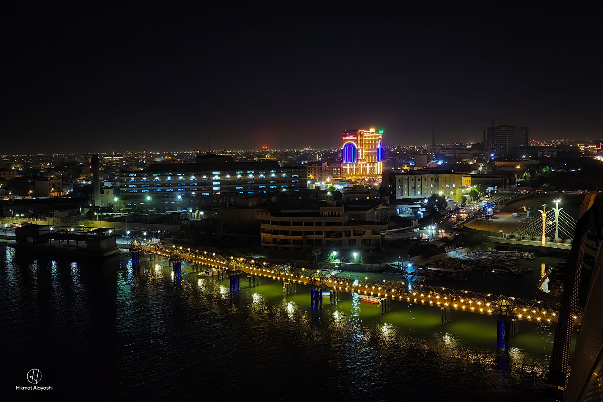night view of Basra city with illuminated bridge and buildings