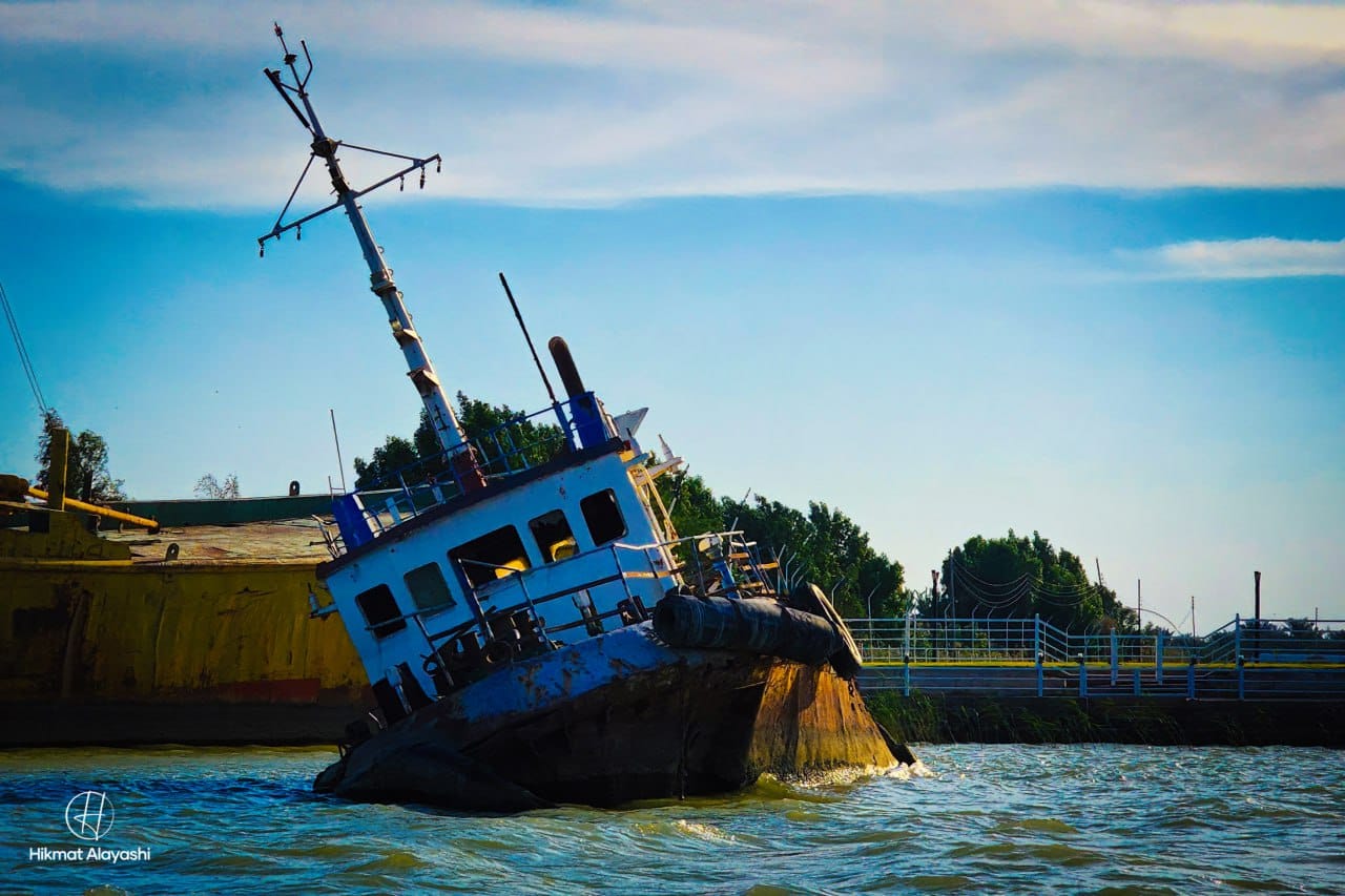 old ship leaning in the water near Basra