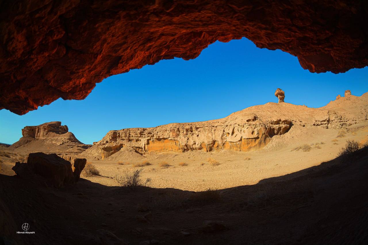 view of desert mountains through a cave opening in Karbala Iraq