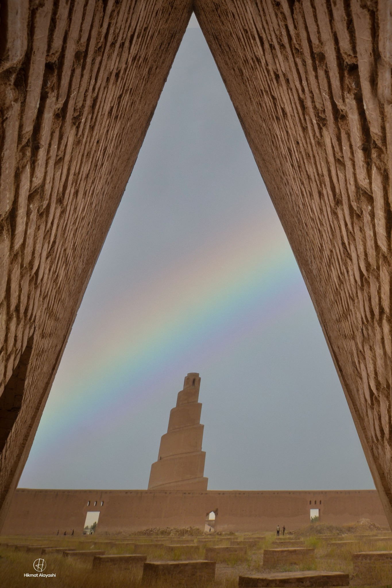 spiral minaret of Samarra mosque with rainbow above it