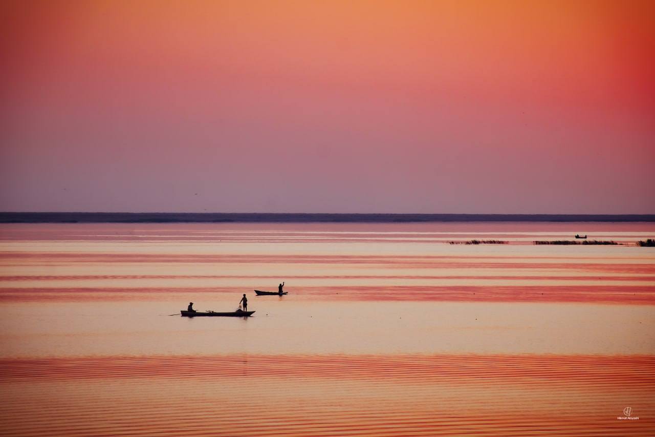 color lake with boat in sun site, Iraq