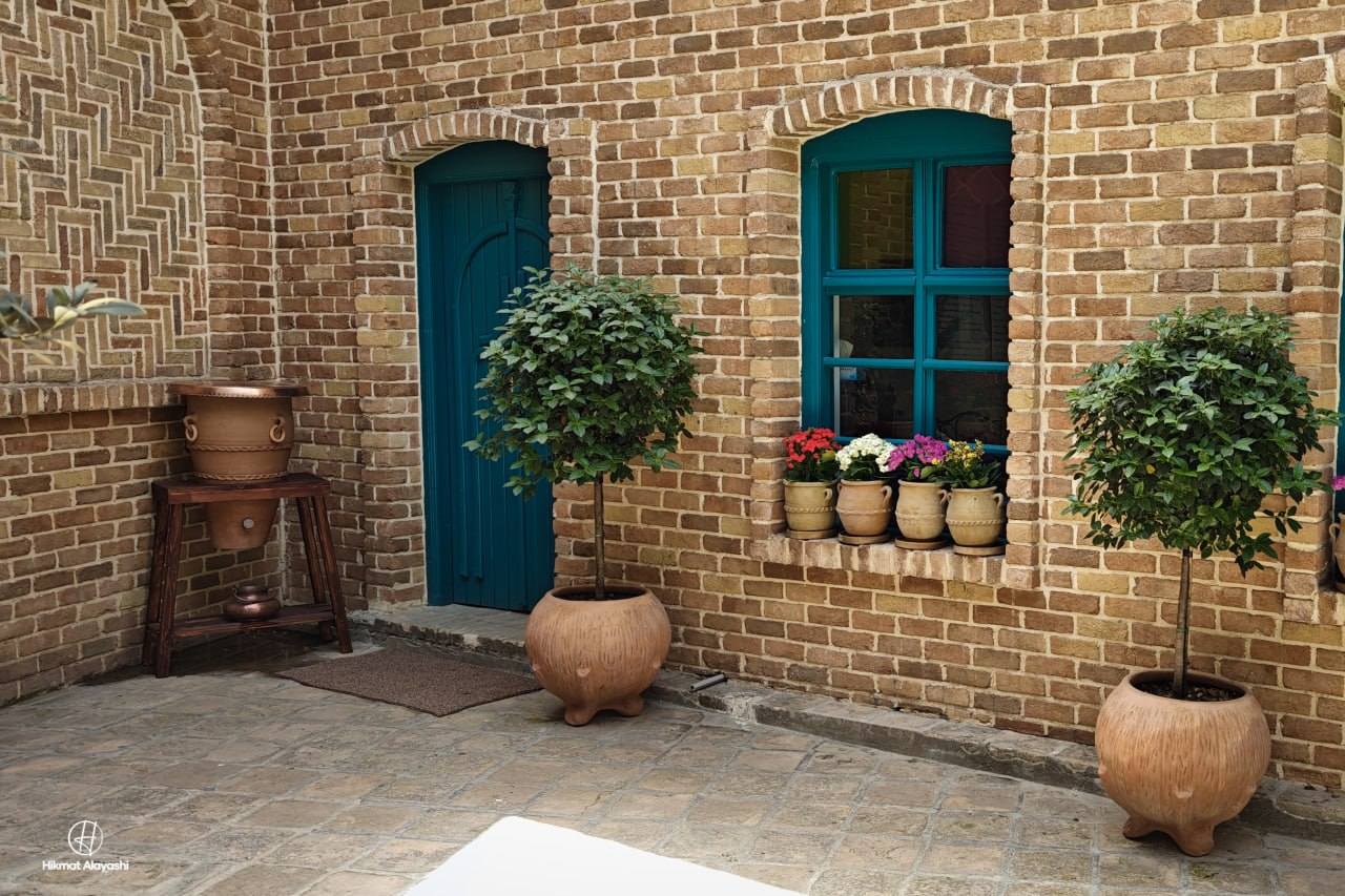 traditional brick house with blue door and windows in Sulaymaniyah, Iraq