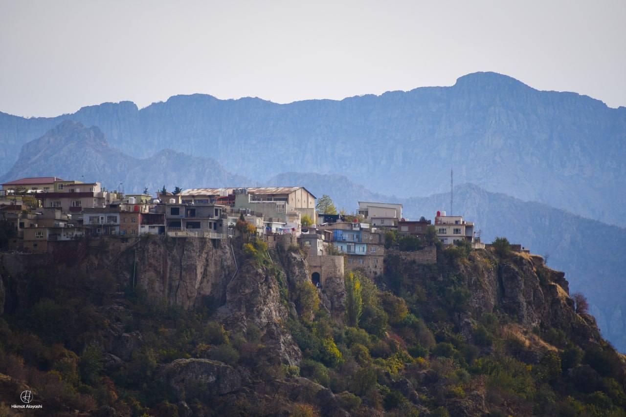 village on a cliff with mountains in northern Iraq