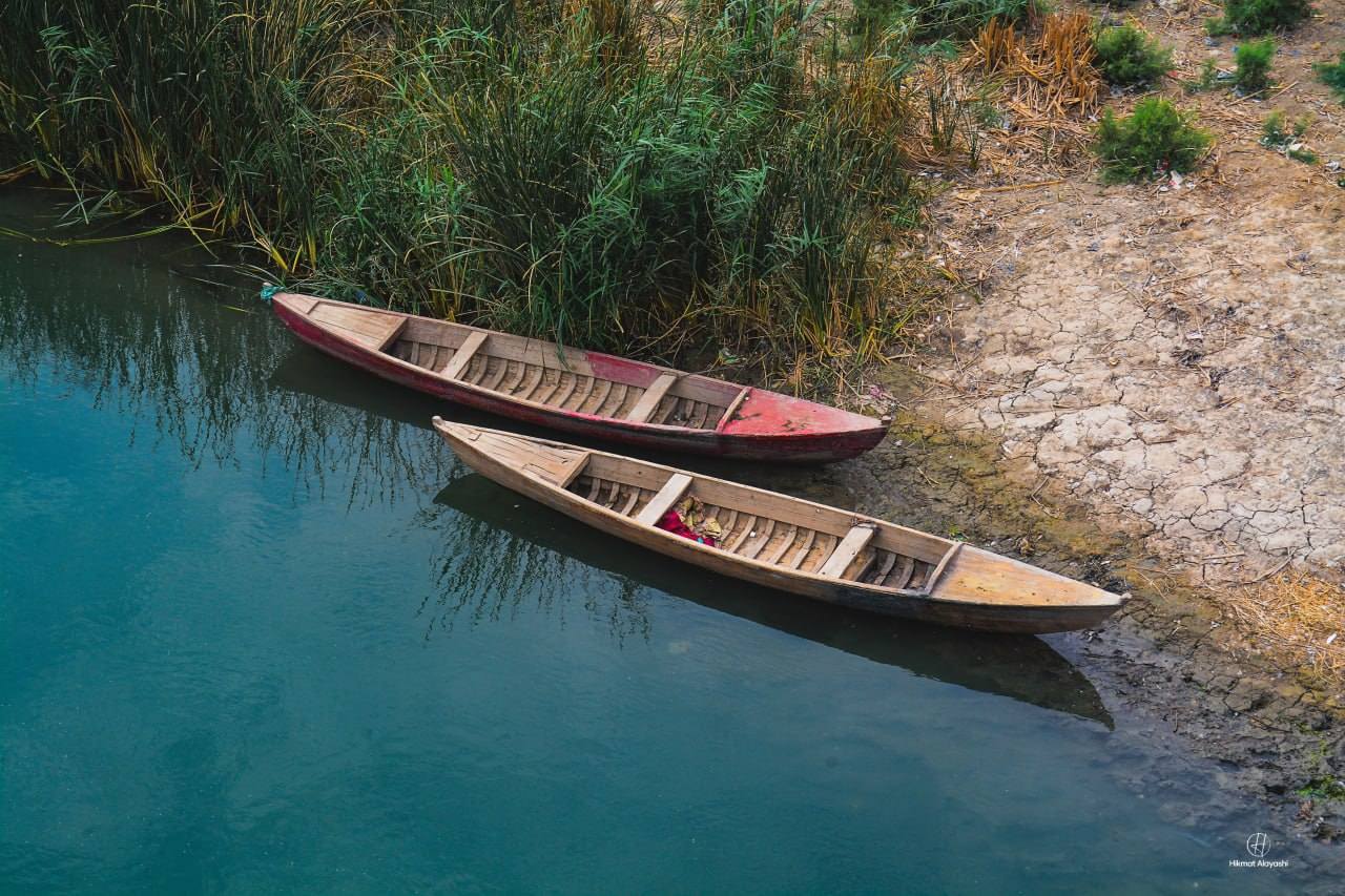 traditional wooden boats in southern Iraq marshes
